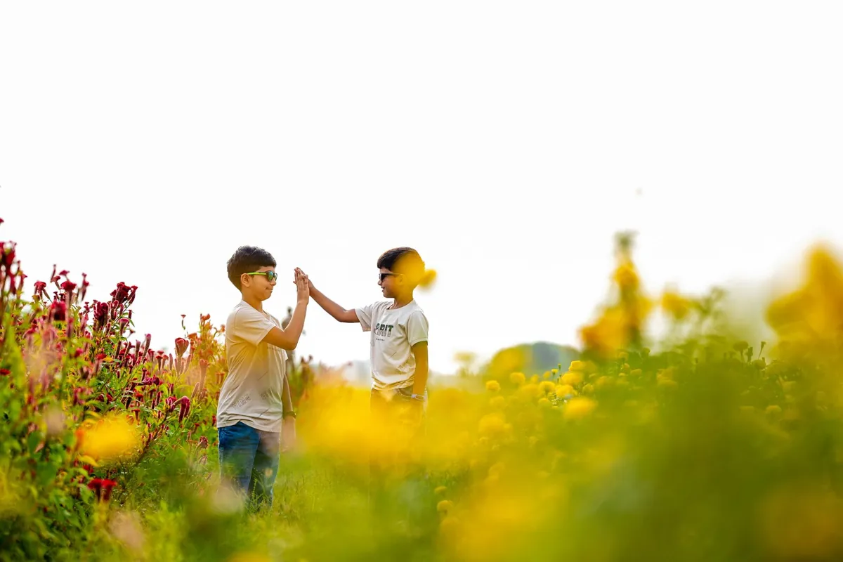 Children running together in a flower garden